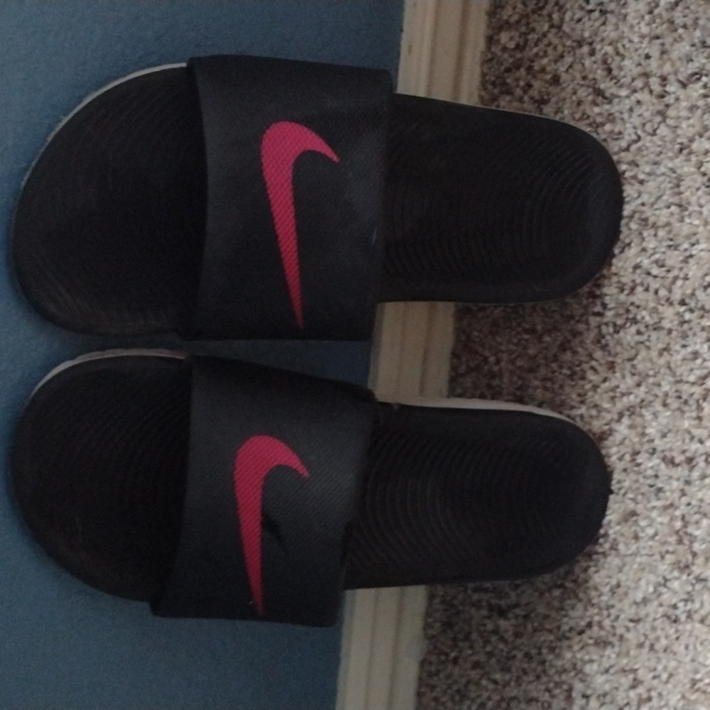 Pink and black Nike slides